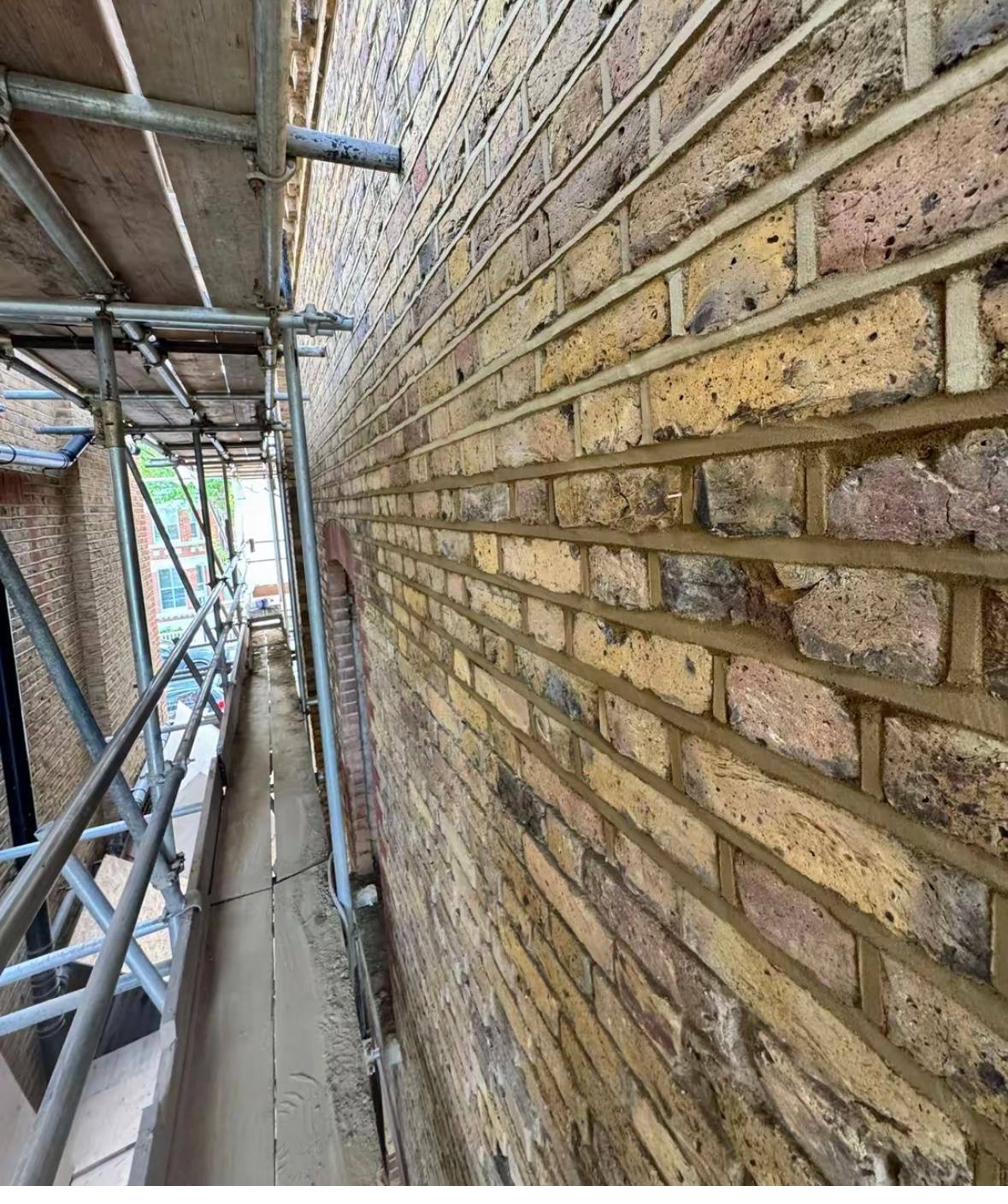 Traditional lime repointing on yellow stock brickwork.